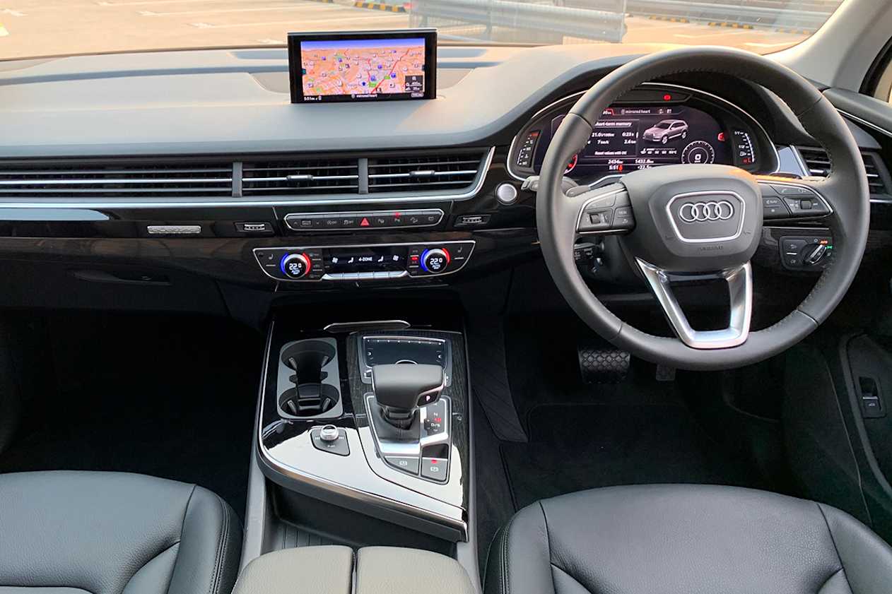 Media is covered with a retractable 8.3-inch media screen with touchpad and rotary dial controller.